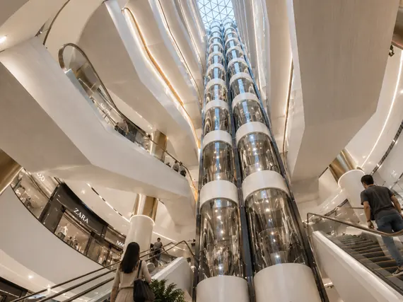 Glazed lifts rising through the atrium