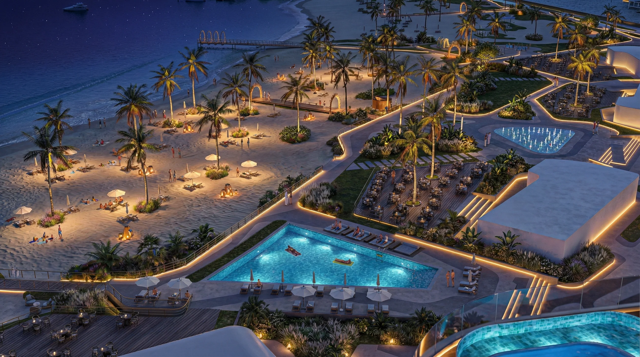 The podium pools and beach lit at night